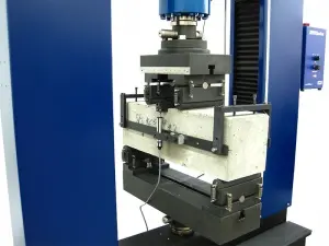 Closeup of fixture for ASTM C1609 concrete flexural testing
